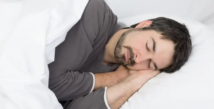 man sleeping on bed